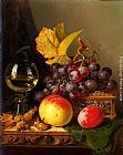 A Still Life of Black Grapes, a Peach, a Plum, Hazelnuts, a Metal Casket and a Wine Glass on a Carved Wooden Ledge by Edward Ladell